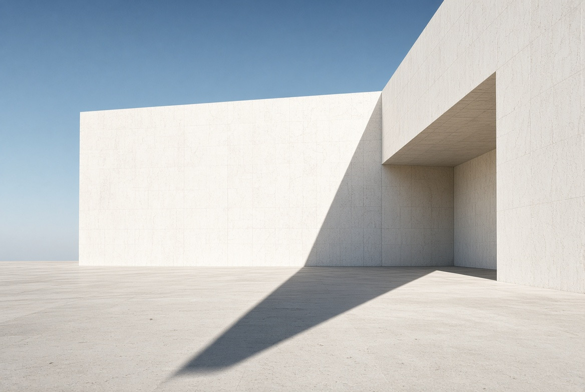 A sun-white architectural wall before the first long shadow